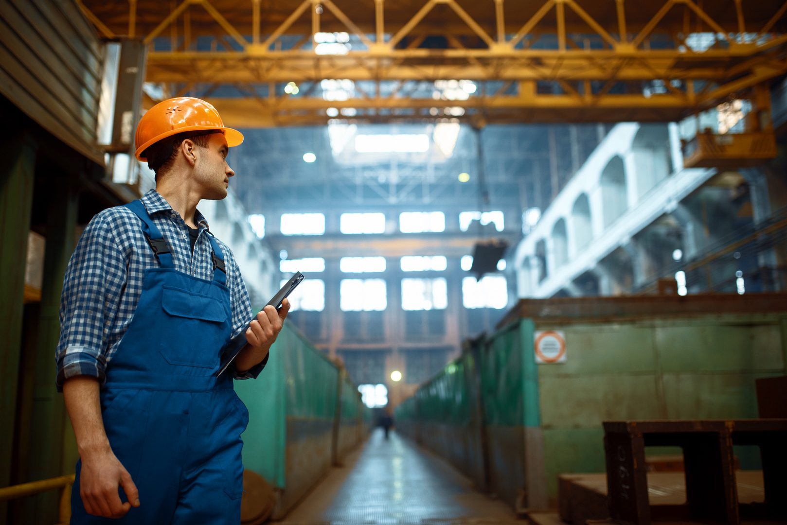 Master looks at work of crane operator on factory